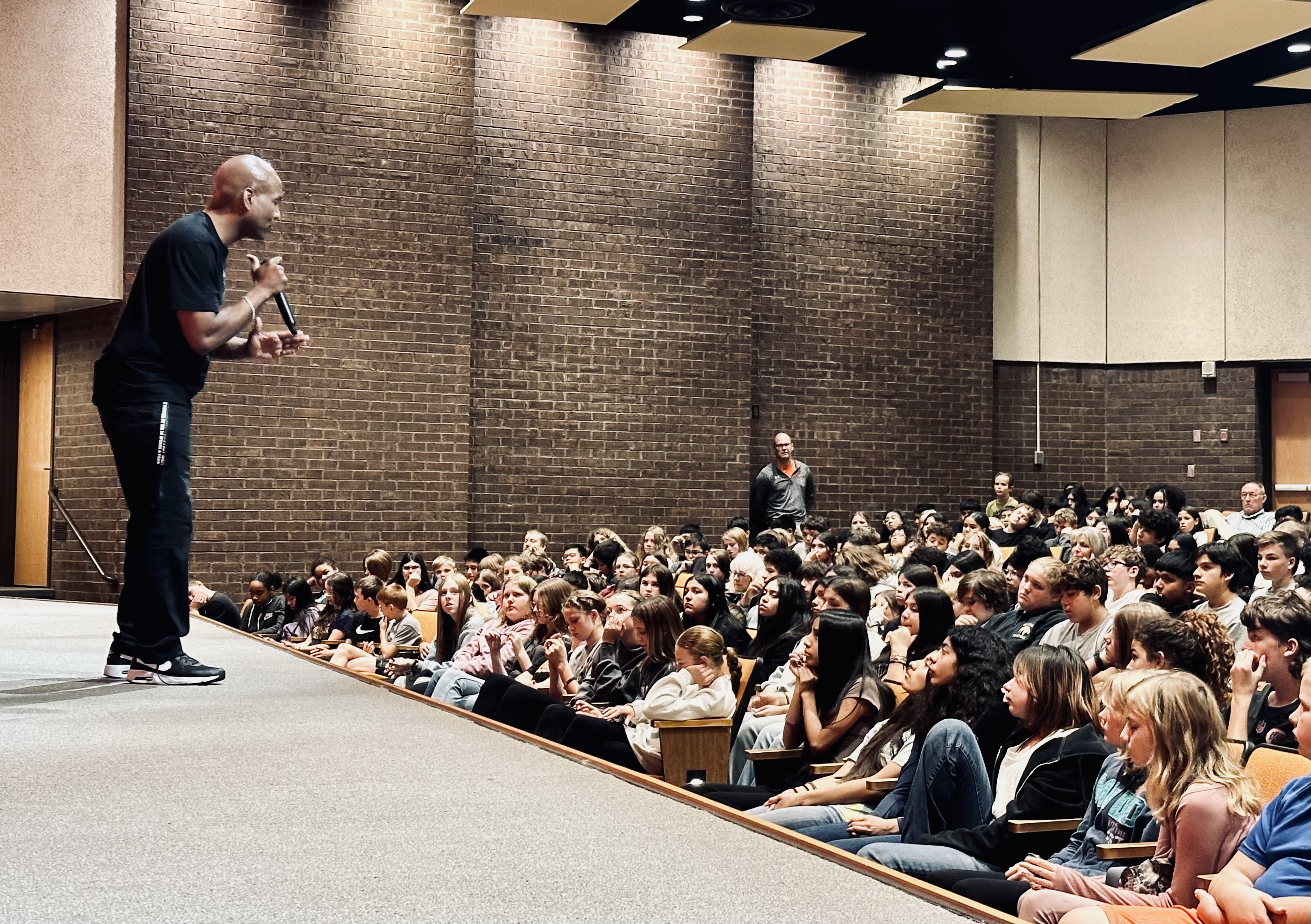 Coach Pete speaking with students